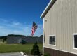 American flag flying outside Stehling's Taxidermy facility in Wisconsin under a clear blue sky