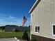 American flag flying outside Stehling's Taxidermy facility in Wisconsin under a clear blue sky
