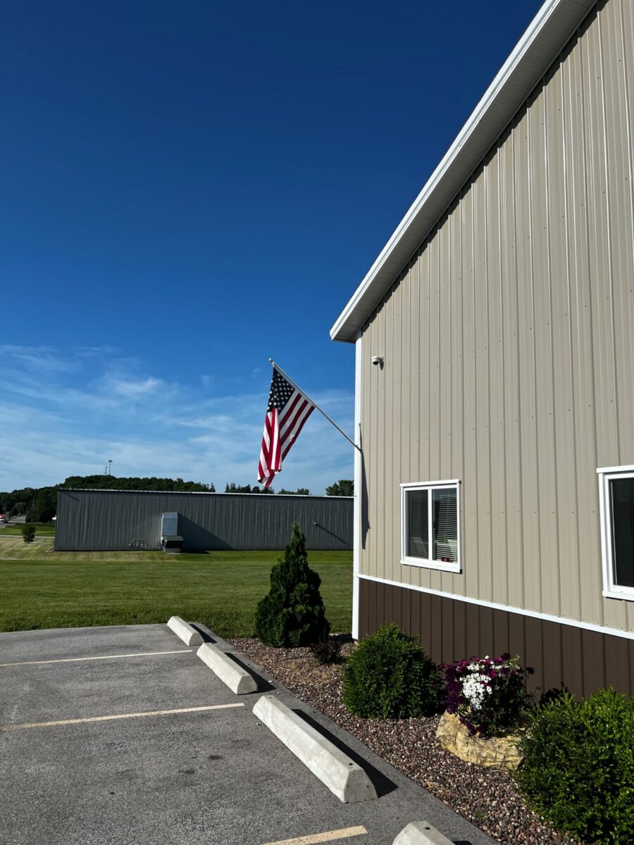 American flag flying outside Stehling's Taxidermy facility in Wisconsin under a clear blue sky